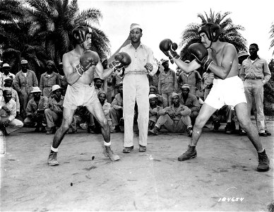 SC 184654 - Sparring off in a friendly fashion, Pfc. Palmer L. Usher, former professional boxer known as "Young Kid Usher", and Pfc. John D. Henry, respectively from Los Angeles, Calif., and Shreveport, La., feel each other out before throwing a punch.