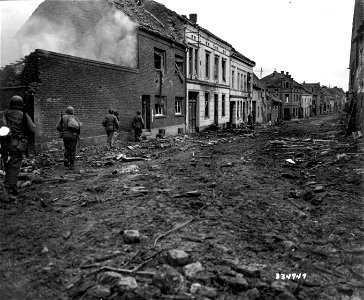 SC 334949 - Infantrymen of the 413th Regiment, 104th Infantry Division, First U.S. Army advance through the debris strewn street in Inden, Germany, to mop up any remaining opposition after one of their toughest fights for the town. photo