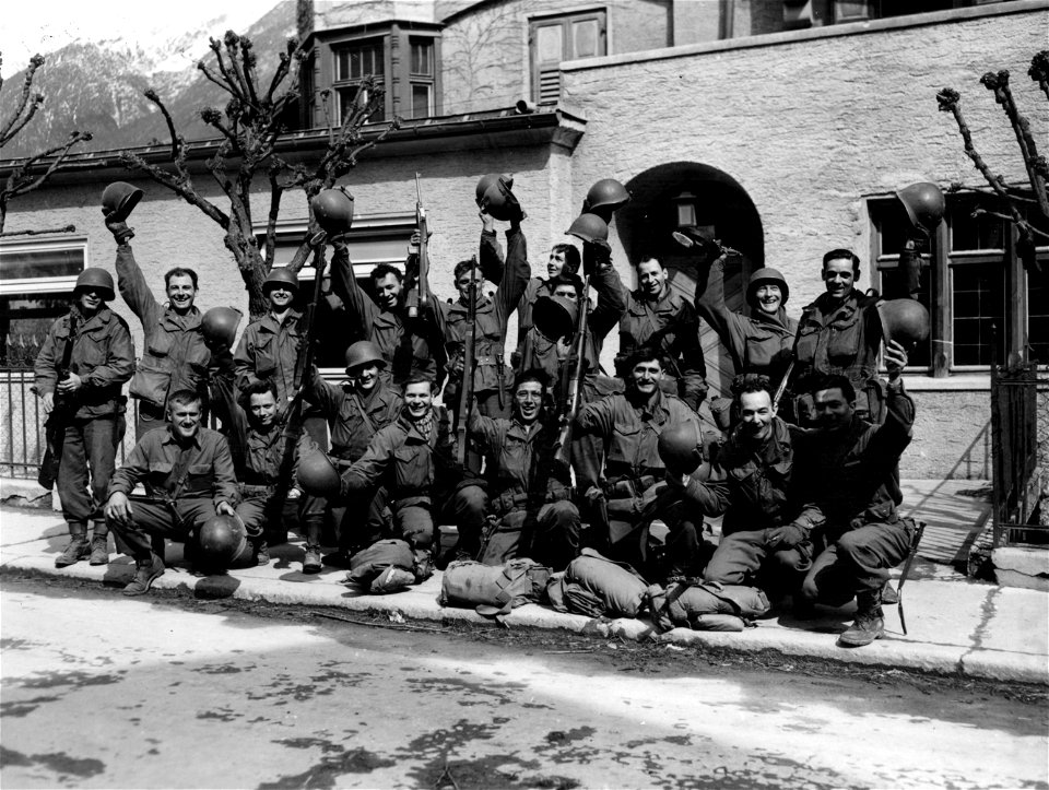 SC 334915 - Yanks in Landeck, Austria, wave their rifles and helmets with joy as they heard 19th German Army surrendered today.