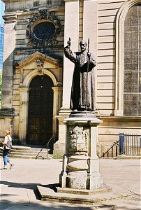 The first bishop of Birmingham stands outside his cathedral.