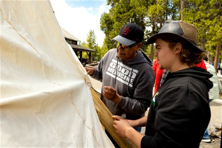 Yellowstone Tribal Heritage Center opening day 2023:Artis Mike Redman shows how to tie the canvas together