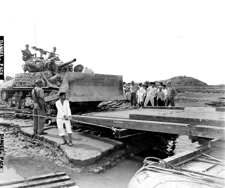 SC 349064 - An M4 heavy tank with bulldozer blade of the 1st Marine Div. is loaded on pontoon barge to be transported across Han River, during offensive launched by U.N. forces against the North Korean enemy troops in that area.