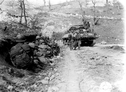 SC 270865 - Members of the 126th Mt. Engrs., 10th Mt. Div., and a TD of the 701st TD await their chance to make the 300 yards into Tole. photo