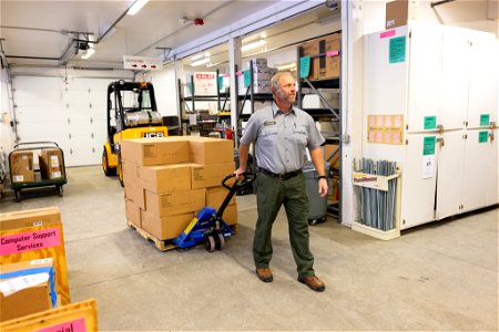 Tim Glover, hauling a palette in the supply center