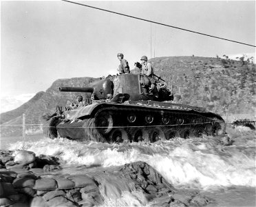 SC 348669 - M-26 tanks of the 6th Tank Bn., 24th Inf. Div. cross the Kumbo river on an underwater crossing, consisting of rocks and sandbags reinforcing the riverbed. 18 September, 1950.