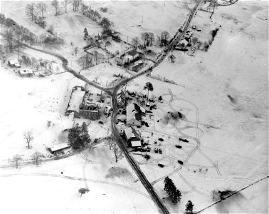 SC 329977 - Aerial view showing armor and infantry of the 6th Armored Division advancing through the snow in the direction of Northeast Bastogne, Belgium. 13 January, 1945. photo