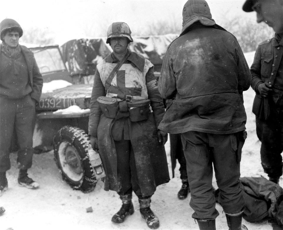 SC 199035-S - This Nazi medic captured by First Army men near Butgenbach, Belgium, carried medical supplies in two US field glass cases. 24 January, 1945.