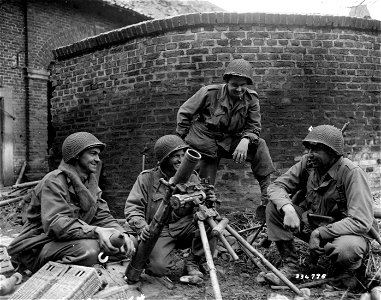 SC 336798 - Four infantrymen of Company F, 413th Regiment, 104th Division, First U.S. Army, pose with a captured German 81mm mortar that they used to knock out a German 85mm gun near Duren, Germany. photo