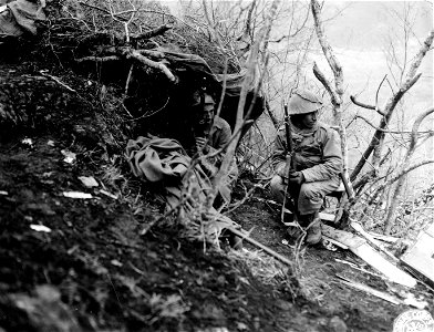 SC 184718 - Two soldiers of the 5th Rifle Regiment, 2nd Moroccan Division (French) sit near their foxhole on the slopes of Mt. Pantano after they have helped to chase the enemy from the rest of the hill. 18 December, 1943.