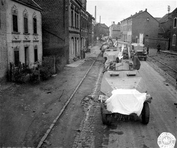 SC 195570 - Half-track Nazi armored cars bearing white surrender flags are taken into custody by Yanks at Aachen. 24 October, 1944.