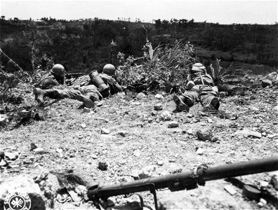 SC 270796 - Infantrymen of the 17th Regt., 7th Div., keep down and and carefully probe the the ample vegetation for the enemy. Okinawa. 21 April, 1945. photo