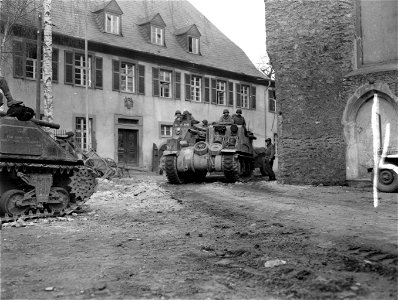 SC 335283 - Elements of the 9th Armored Division, 1st U.S. Army, roll through the streets of Limburg, Germany. 27 March, 1945.