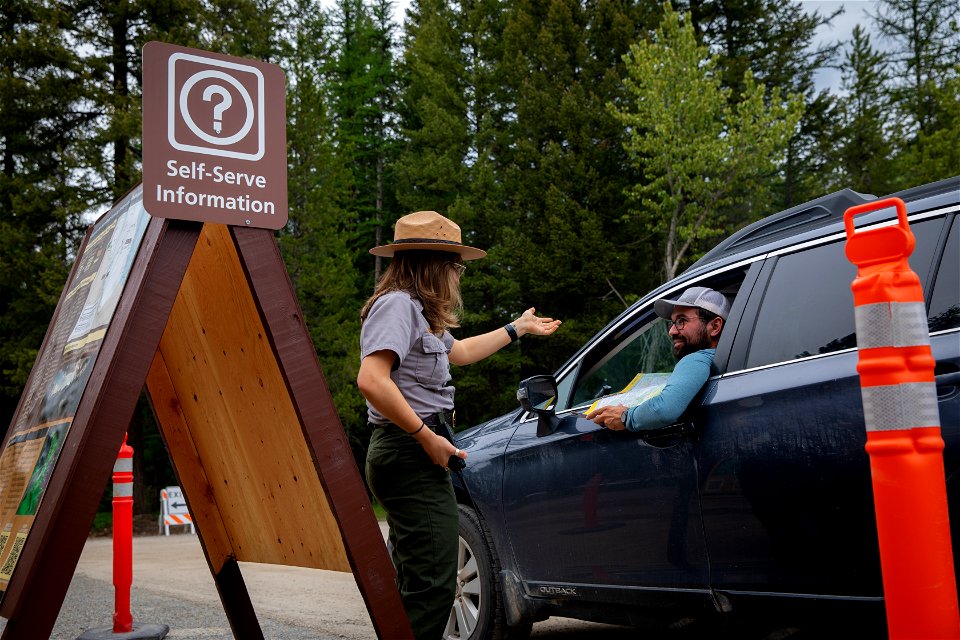 Ranger assists a visitor with questions about vehicle reservations photo