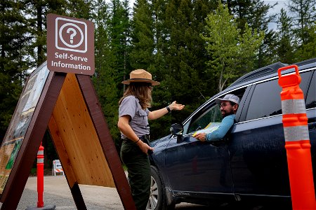 Ranger assists a visitor with questions about vehicle reservations