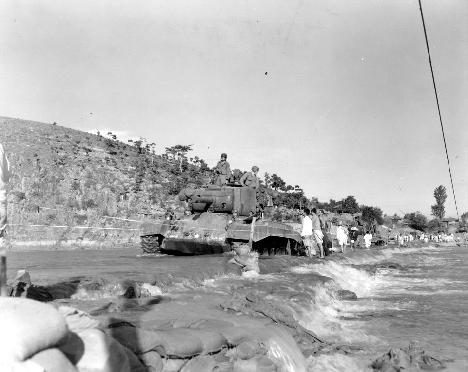 SC 348668 - M-26 tanks of the 6th Tank Bn., 24th Inf. Div. cross the Geumho River on an underwater crossing, consisting of rocks and sandbags reinforcing the riverbed. 18 September, 1950.
