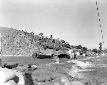 SC 348668 - M-26 tanks of the 6th Tank Bn., 24th Inf. Div. cross the Geumho River on an underwater crossing, consisting of rocks and sandbags reinforcing the riverbed. 18 September, 1950.