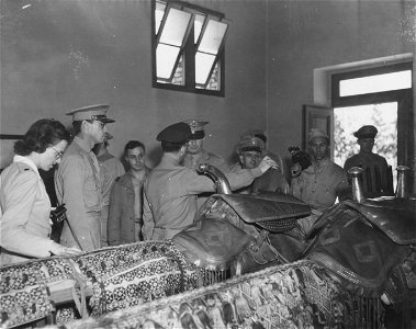 SC 405093 - The saddles used by King Farouk being admired by a crowd of American soldiers during their visit to the King's experimental farm Tefteesh of Inshas, Egypt. 24 October, 1943.