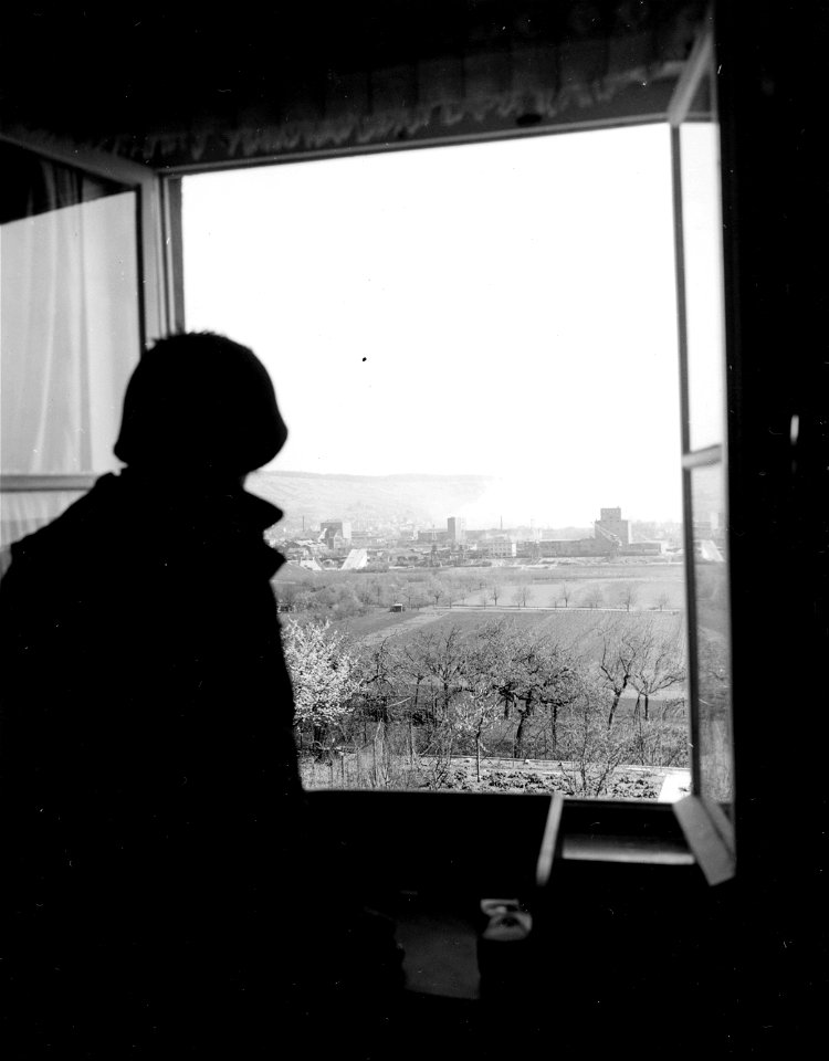 SC 335304 - A 7th U.S. Army soldier of the 100th Division looks out of O.P. overlooking the German city of Heilbronn. 9 April, 1945. photo