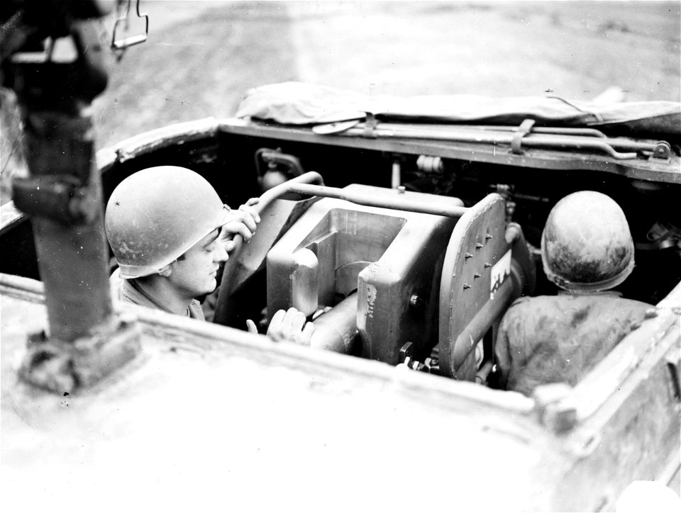 SC 195752 - Pvt. Louis Kocherka, of Newark, New Jersey, loads a 90mm shell in a new high-powered T.D., recently acquired by a Third Army tank destroyer battalion.