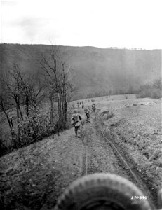 SC 270830 - Infantrymen of the 2nd Bn., 60th Regt., 9th Division, U.S. First Army, move forward to cross the Roer River and attack Nideggen, Germany. 27 February, 1945. photo
