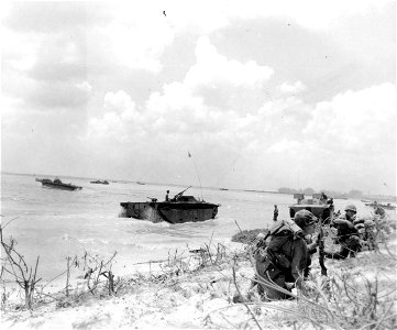 Marines advancing on beach. Saipan. 15 June, 1944.