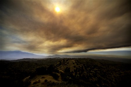 Smoke from the Apple Fire over desert hills and San Jacinto