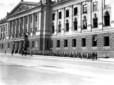SC 335326 - In front of the University of Leipzig, the Police force of the City are rounded up by infantrymen of 69th Infantry Division, 1st U.S. Army.