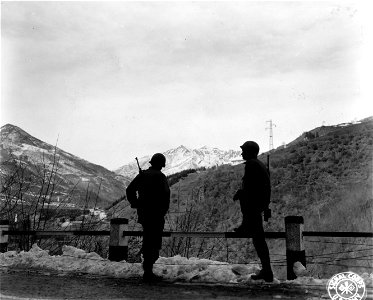 SC 270839 - L-R: Cpl. Charles E. Gardner, 3581 E. 142nd St. Cleveland, Ohio, and Cpl. Wayne L. Ritter, 720 Sandusky St., Ashland, Ohio, take a good look at the Apennine landscape. 6 February, 1945. photo