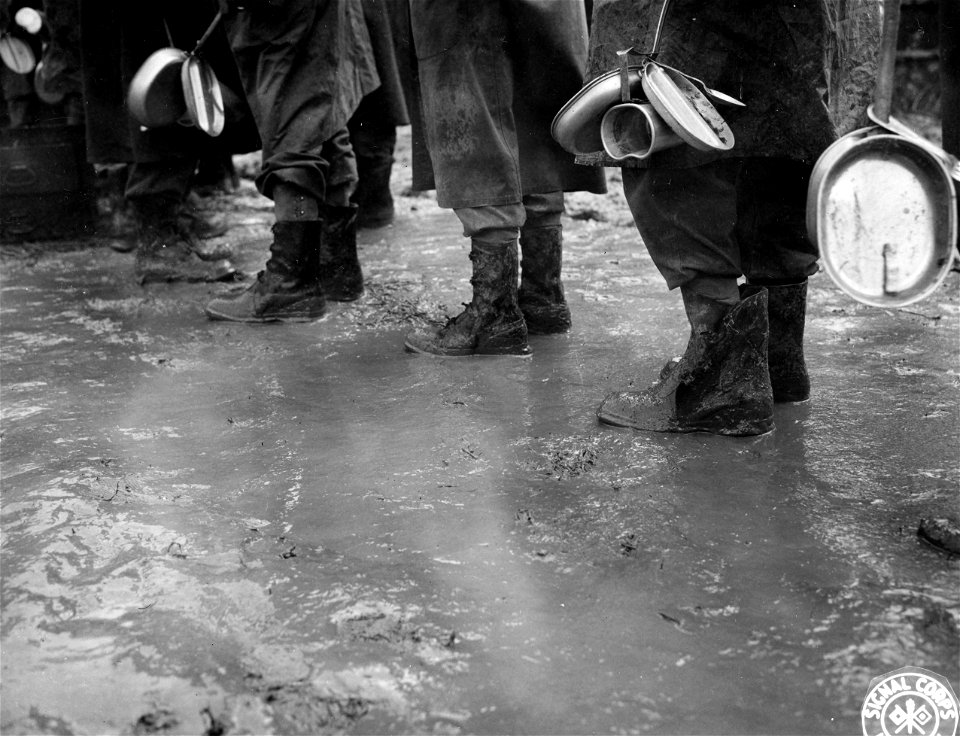 SC 196049 - GIs with mess gear standing in the mud in Gothic Line in Apennines. photo