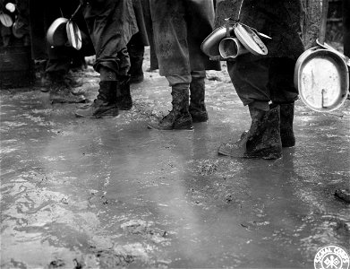 SC 196049 - GIs with mess gear standing in the mud in Gothic Line in Apennines.