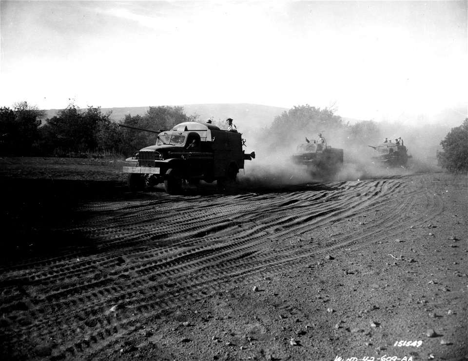 SC 151549 - Trucks and men battle dust and frigid weather on Hawaii pole line construction by the 254th Signal Company. photo