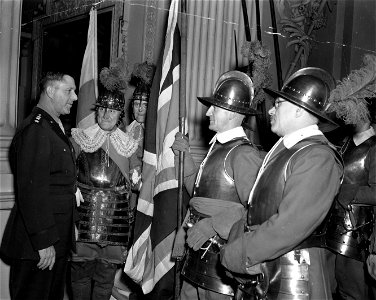 SC 329900 - Lt. Gen. Jacob L. Devers, left, chats with colorfully costumed pikemen who exchanged a flag of the city of London with one from Chicago during a ceremony held recently in London in the Lord Mayor's mansion. 10 December, 1943.
