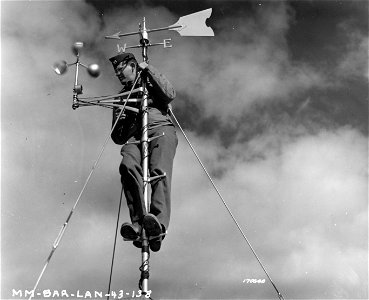 SC 170040 - Capt. F. J. Cole, Group Weather Officer, is testing the anemometer. 16 February, 1943.