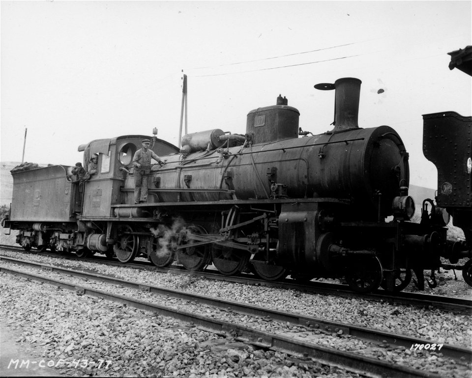 SC 170027 - J. M. McClellan - an American soldier operates a French locomotive in the railway yards in North Africa. 17 February, 1943.