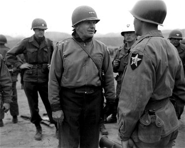 SC 364208 - Lt. Gen. Edward M. Almond, left, CG X Corps, stops to talk to member of the 9th Regt., 2nd Inf. Div., during his tour of inspection of the Regt. area. photo