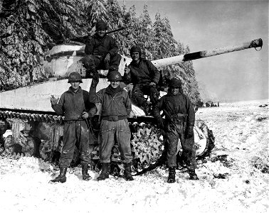 SC 335399 - Left to right: Cpl. Cecil M. Lindsey, Springfield, Mo.; Cpl. Walter P. Waymer, Seymour, Conn.; Capt. John Megglesin, Aurora, Ill., all of the 42nd Tank Battalion, 11th Armoured Division. photo