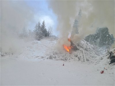 Pile burning on the Gifford Pinchot National Forest on Nove 30, 2022. Snowy conditions reduce the risk of fires escaping safety perimeters while still allowing burn objectives to be accomplished.