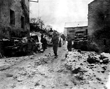 SC 374831 - Men advance through town, alert for enemy snipers or resistance.
