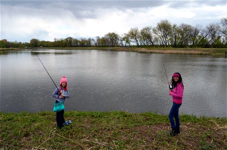 Girls pose while fishing