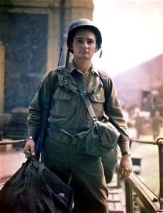 C-2375 - Striding up the gangplank to board a CBI-bound vessel is Cpl. Charles Hannon, Akron, Ohio, who left with his Combat Engineer unit from the Calais Staging Area, near Marseilles, Southern France, to the Pacific. photo