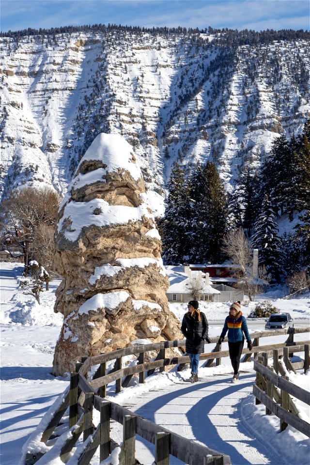 Visitors explore the boardwalk near Liberty Cap in Mammoth Hot Springs (2) photo