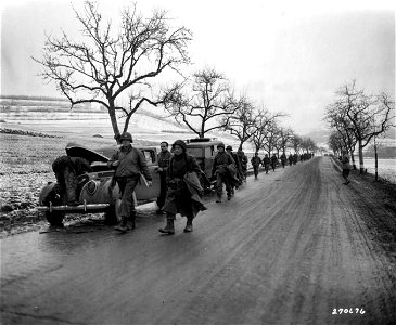 SC 270676 - U.S. troops of the 5th Infantry Division, U.S. Third Army, Luxembourg, advance through wintry-looking countryside on their way to the frontlines. 22 December, 1944.