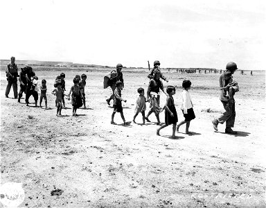 SC 405067 - U.S. soldiers escorting native children to safety. photo