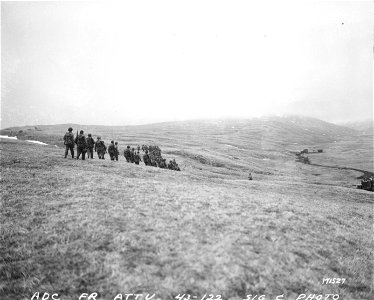 SC 171527 - Yank infantry advances toward the rocky ridge where the Japs established their defence positions. Attu, Aleutians. 1943. photo