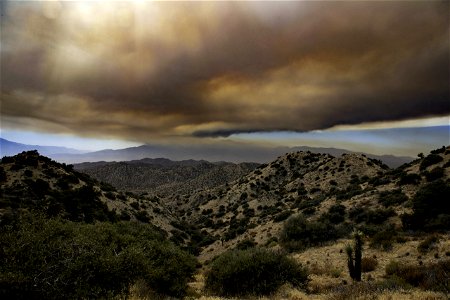 Smoke from the Apple Fire over desert hills photo