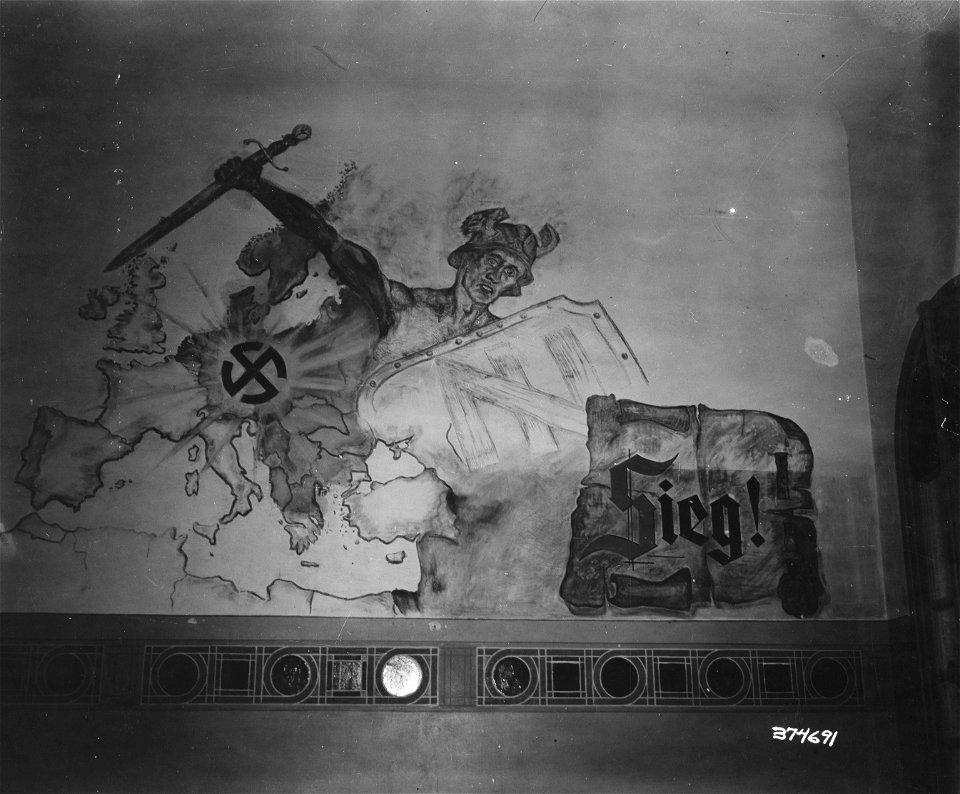 SC 374692 - This once was a German hospital in Sees, France, as can be seen by the mural, however the Germans have relinquished their hold and the Americans have taken over. 14 August, 1944.