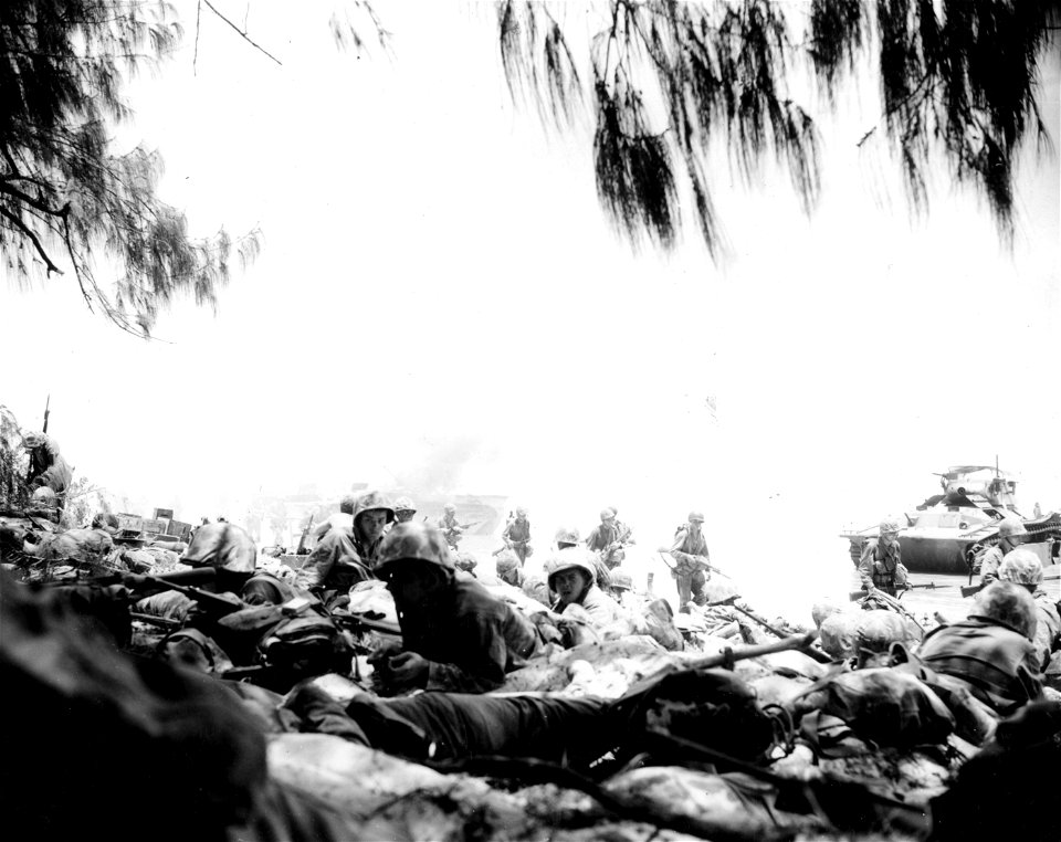 "H" Hour Marines hit the beach and the deck (fall flat) under fire of Jap guns on Saipan.