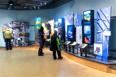 Exploring exhibits at Old Faithful Visitor center in winter photo