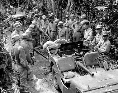 SC 184780-S - Chinese troops examine the barrel and breech assembly of captured Japanese 37mm anti-tank gun which is being loaded into a jeep. photo