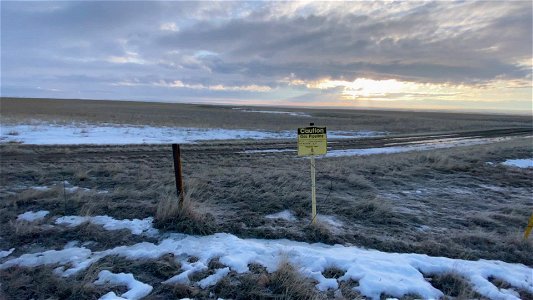 Sequence 2 pipeline sign along road and fence